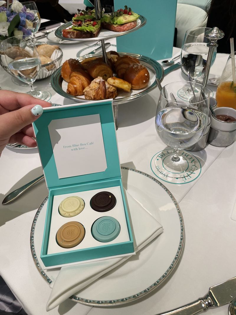 A gift box of curated confections, opened and presented at the table.