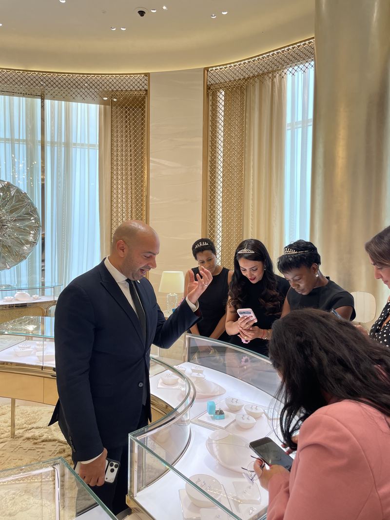 A jewellery boutique showroom, guests guided through the display cases.